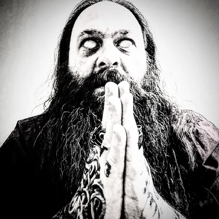 Reverend Meantooth staring with whited-out eyes, hands pressed together